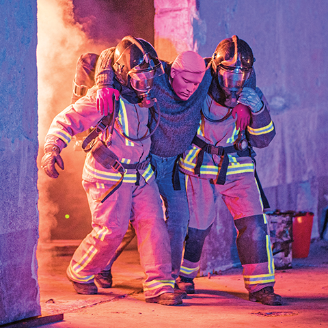 Rescue Randy Manikin being carried by firefighters